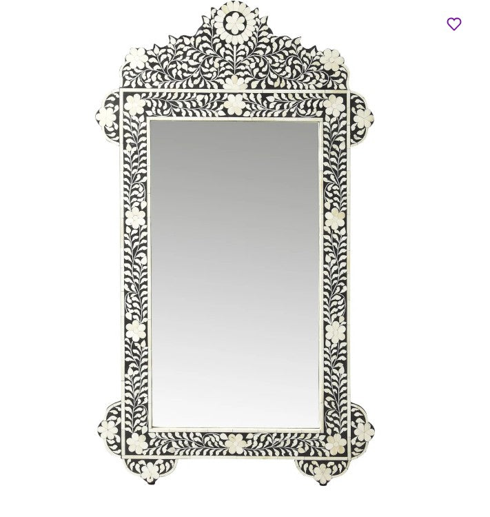 Decorative wall mirror with intricate black and white pattern on a white background