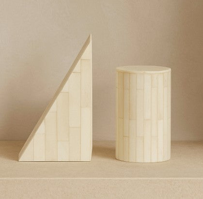 Two wooden geometric shapes on a neutral background