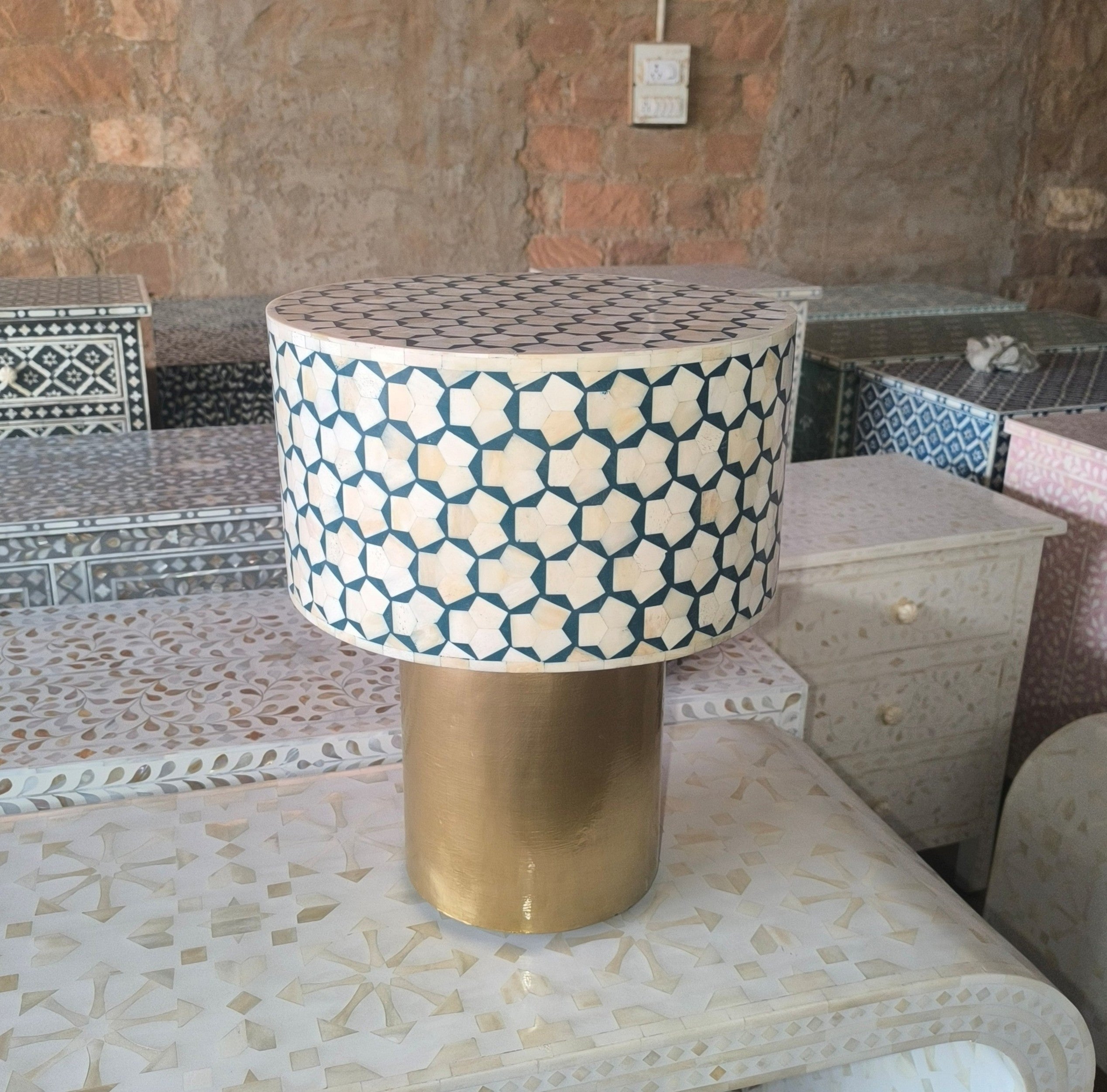 Decorative table with geometric pattern and gold base.