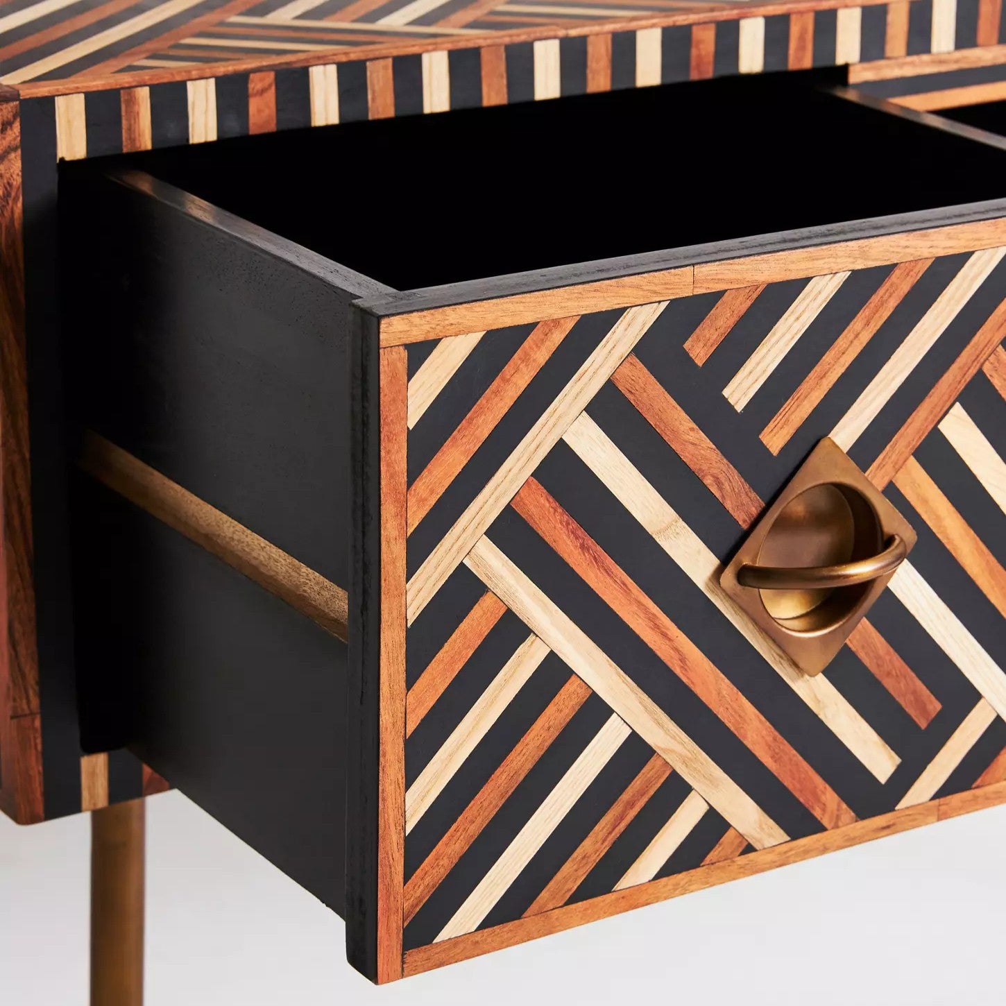 Wooden drawer with geometric pattern and gold handle on a white background