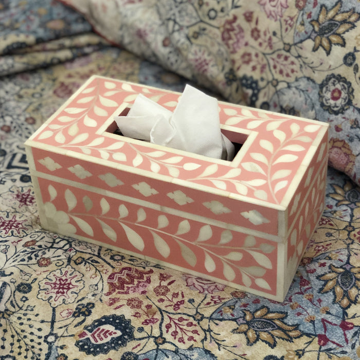 Decorative tissue box with floral pattern on a textured fabric background
