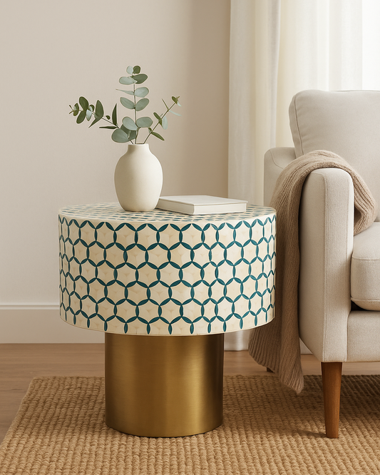 Round side table with geometric pattern and gold base in a living room setting