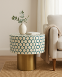 Round side table with geometric pattern and gold base in a living room setting