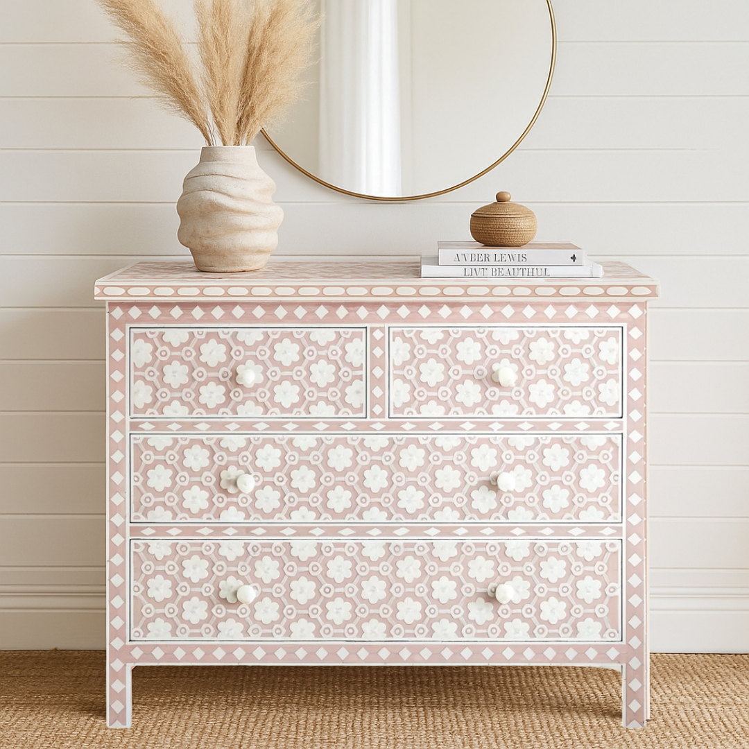 Decorative chest of drawers with floral patterns in a room with a wooden floor and white walls.