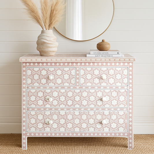 Decorative chest of drawers with floral patterns in a room with a wooden floor and white walls.