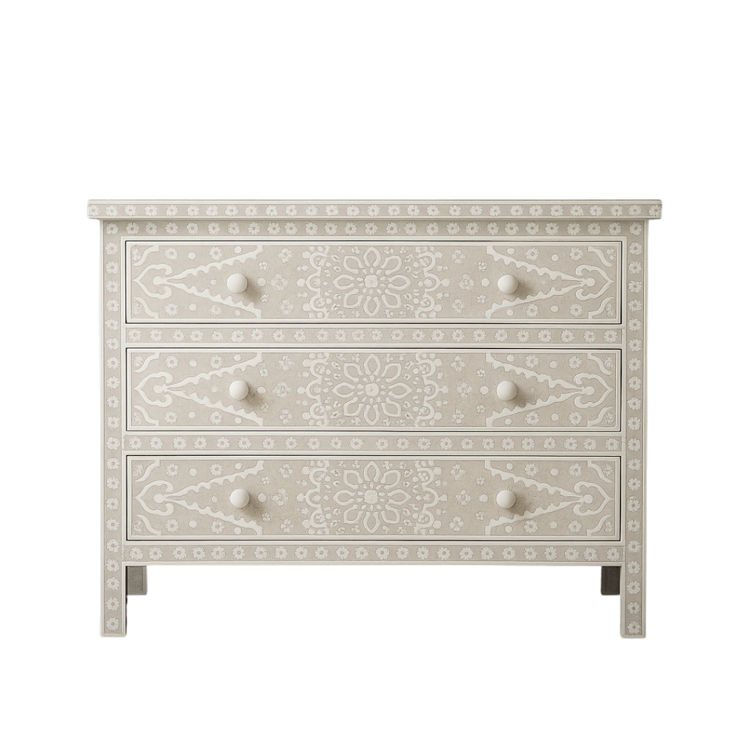 Decorative chest of drawers with intricate patterns on a white background