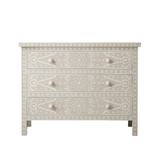 Decorative chest of drawers with intricate patterns on a white background