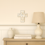 Decorative setup with a lamp, books, and a vase on a wooden surface against a light wall.
