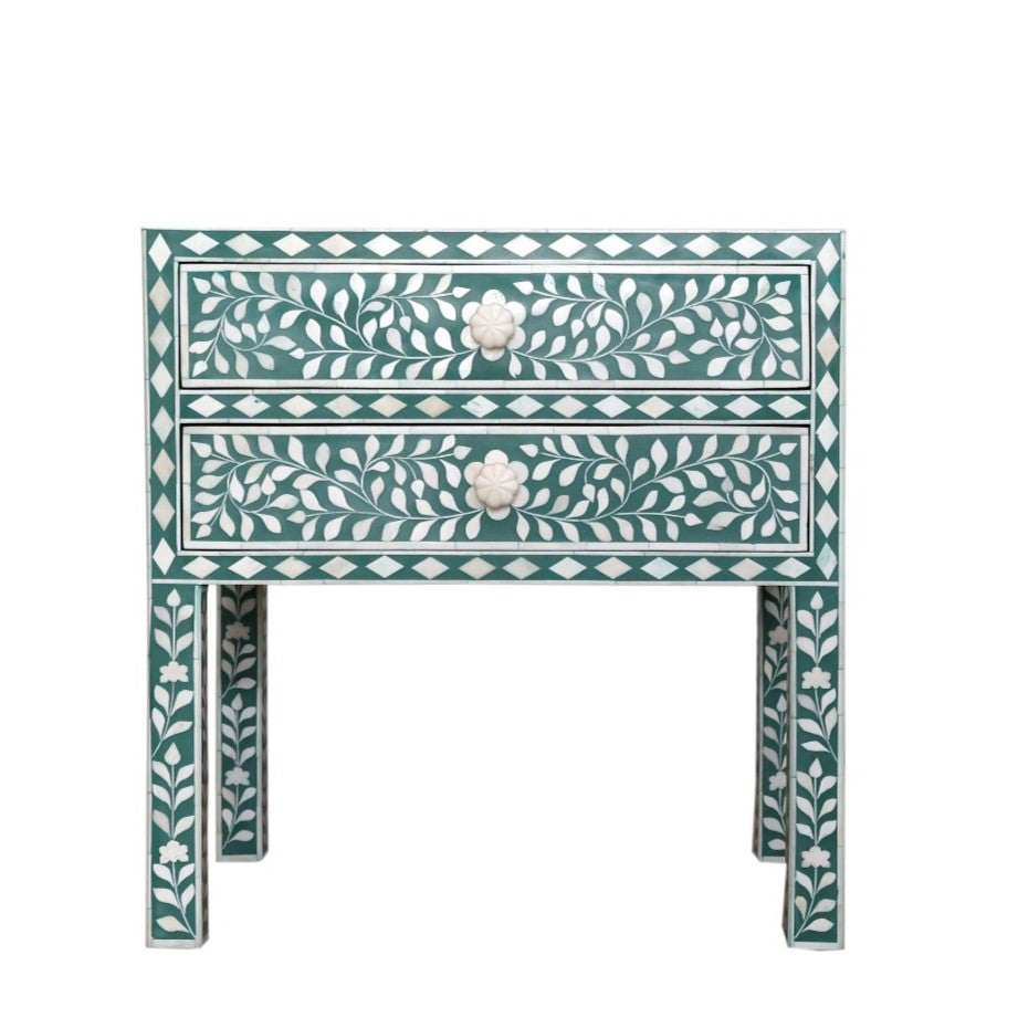 Decorative side table with floral patterns on a white background