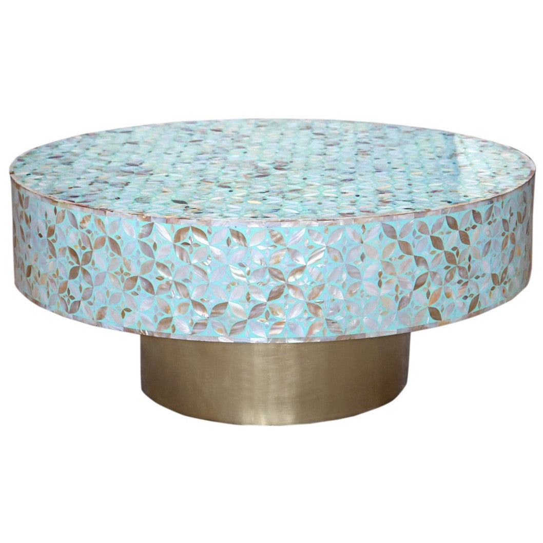 Round coffee table with a decorative top and brass base on a white background