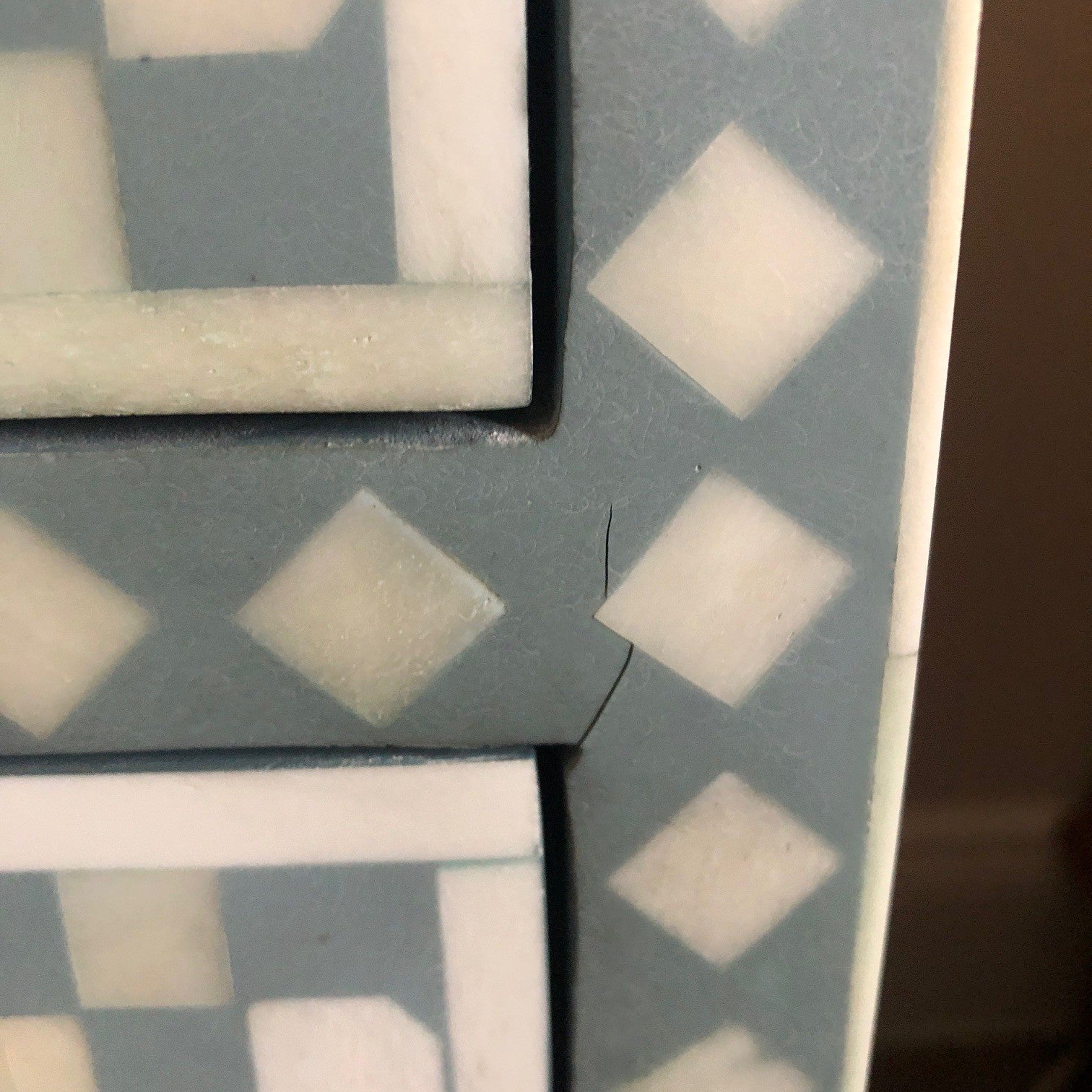Close-up of a geometric patterned tile with a focus on a corner.