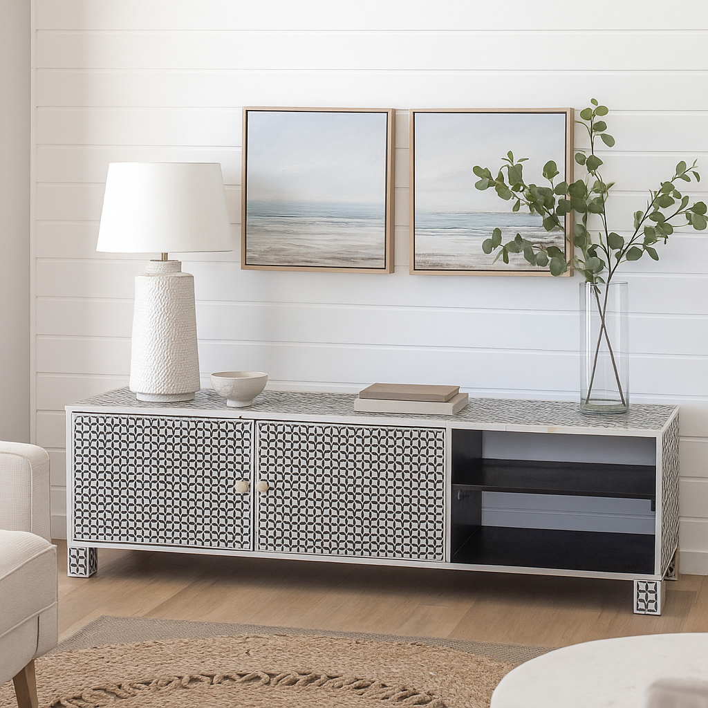 Modern living room with a decorative console table, lamp, and framed artwork.
