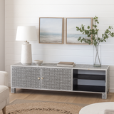 Modern living room with a decorative console table, lamp, and framed artwork.