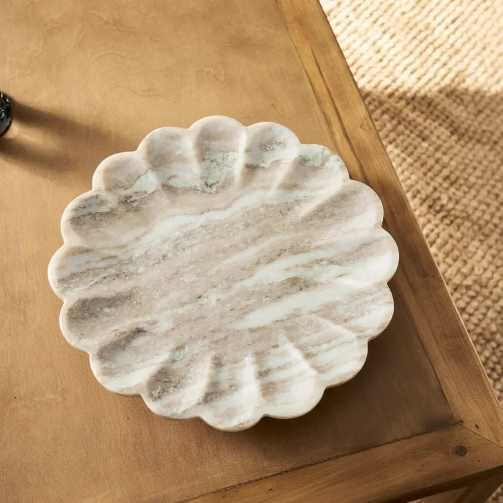 Marble scalloped dish on a wooden surface