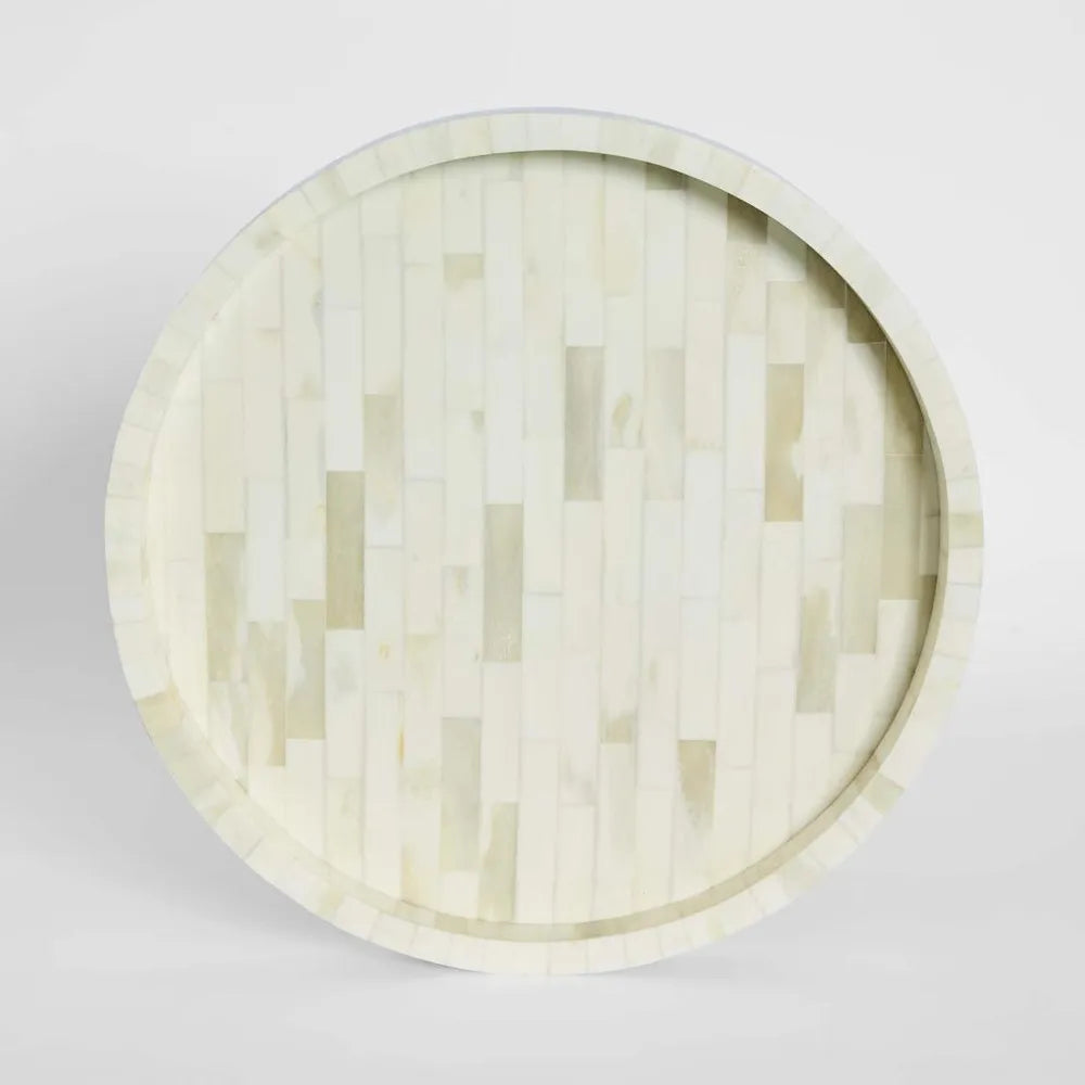 Round wooden tray with a geometric pattern on a light gray background