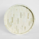 Round wooden tray with a geometric pattern on a light gray background