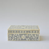 Decorative box with floral pattern on a light gray background