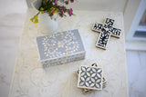 Decorative coasters with floral and geometric patterns on a marble surface.