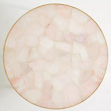 Round marble table with pink and beige marbled pattern on a white background